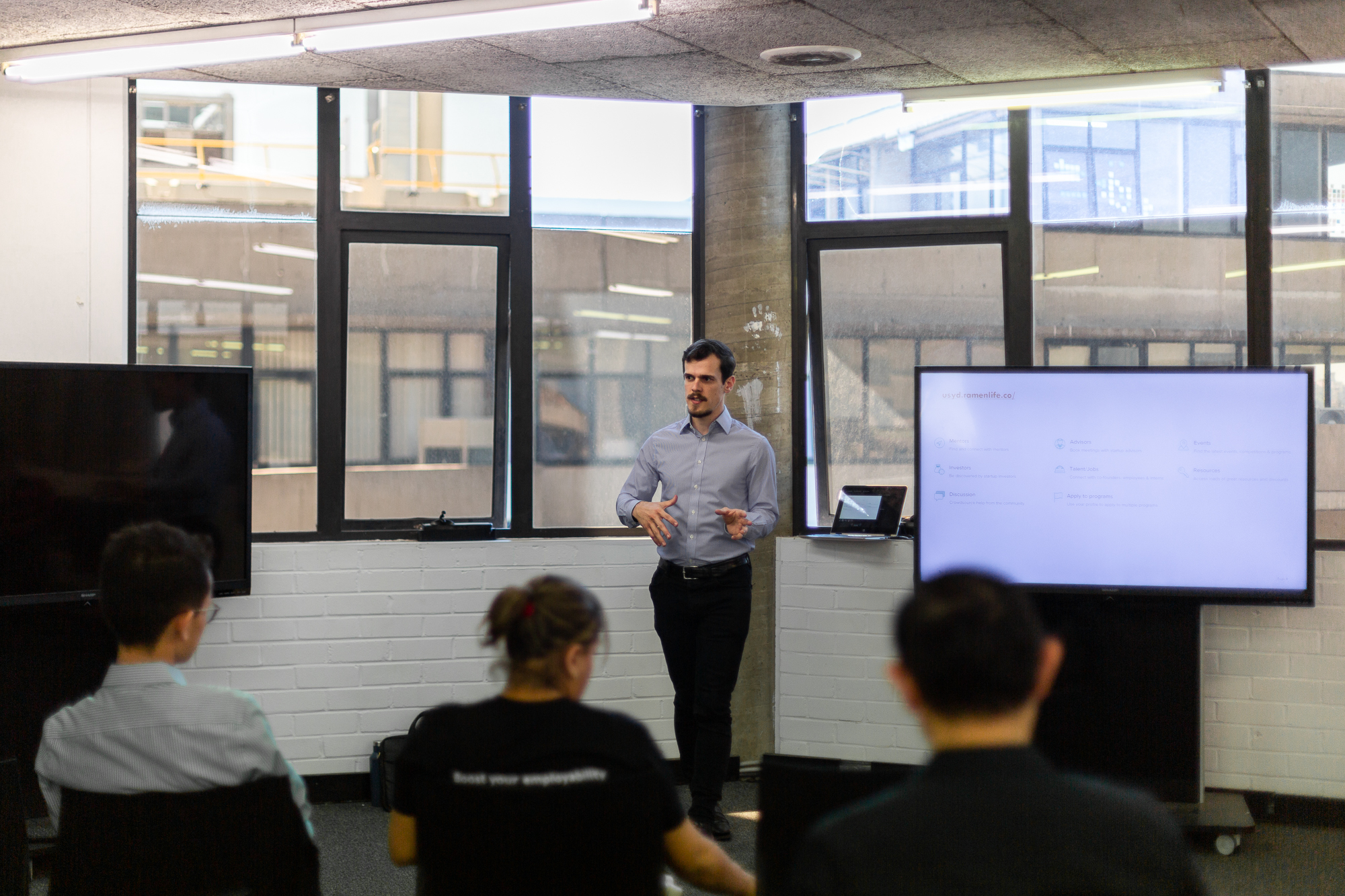 Alex Carpenter speaking at an event